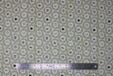 Flat swatch Love Wreath fabric (white fabric with small circular green leafy wreaths allover with single letters inside in black and beige creating words "HOME" "JOY" "LOVE" "HOPE", some wreaths have black or beige hearts)