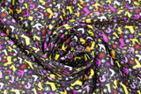 Swirled swatch spirit animals fabric (black fabric with tiny woodland creature silhouettes and abstract floral in yellow, cream, purple, red colourway)