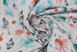 Swirled swatch whale themed fabric in Sea Life White (assorted cartoon sea creatures on white)
