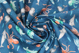 Swirled swatch whale themed fabric in Small Sea Life (assorted small cartoon sea creatures on blue)