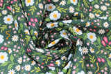 Swirled swatch Flowers & Snakes fabric (charcoal grey fabric with tossed floral in white and pink and greenery allover with coloured snakes and lady bugs)