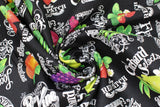 Swirled swatch Wildberry Fields fabric (black fabric with neatly tossed full colour illustrative fruits and veg with white chalk look text behind "wildberry fields" etc.)