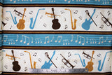 Flat swatch Stripe fabric (cream and blue stripes separated by brown/gold stripes. Cream stripes have tossed musical instrument silhouettes in black, blue, gold and black music notes. Blue stripes subtle staff lines with white music notes)