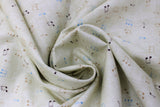 Swirled swatch Sheet Music fabric (cream subtle distressed look fabric with tossed music notes in black, gold and blue)