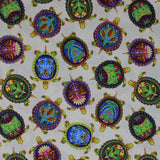 Square swatch Painted Shells fabric (white fabric with tossed green turtles with painted shells in blue, green, pink and yellow shades)
