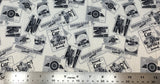 Flat swatch of car service poster signs printed fabric in cream (cream fabric with white/grey/black rectangle bagdes with grey outlines and car emblems/text within in a vintage style)
