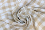 Swirled swatch beige and white medium sized gingham print fabric