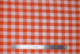 Flat swatch orange and white medium sized gingham print fabric