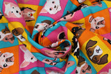 Swirled swatch Dog Check fabric (yellow, orange, blue and pink squares allover with illustrative full colour dog heads in various breeds)