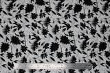 Flat swatch digital printed fabric in black flowers (white fabric with black tossed floral and flowy stems allover)
