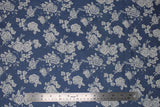 Flat swatch denim look fabric with floral designs in light (light blue fabric with white tossed floral and stems)