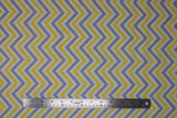 Flat swatch Chevron White fabric (white fabric with sideways grey and yellow chevron stripes each separated by white chevron stripes)