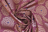 Swirled swatch Flower Burst fabric (burgundy fabric with pale orange and brown/red floral petal burst circles allover with grey center dots)