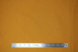 Flat swatch organic slub cotton fabric in mustard yellow
