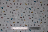 Flat swatch footprints fabric (grey fabric with tiny subtle brown footprint mark lines allover and medium sized tossed assorted foot prints in grey, white, pink, yellow, blue)