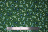 Flat swatch green fabric (medium green fabric with small tossed cartoon style dinosaurs in green and blue shades allover)
