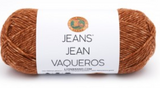 A ball of Lion Brand Jeans in colourway Top Stitch (golden brown with light gold flecks)