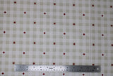 Flat swatch Canada themed printed fabric in linen (white/beige plaid with red maple leaf accents)