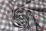Swirled swatch Canada themed printed fabric in grey (white/grey plaid with red maple leaf accents)