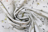 Swirled swatch Vintage Grey Floral fabric (grey fabric with loosely tossed floral and stems with leaves and greenery in yellow, pink, blue shades)