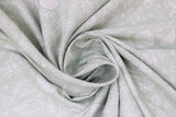 Swirled swatch knitting fabric (grey fabric with small tossed knitting related emblems allover in white: needles, crochet hooks, yarn, hands, socks, scissors, etc.)