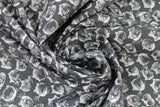 Swirled swatch Kitty Faces fabric (black fabric with tossed illustrative style white kitty heads allover)