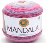 A cake of Lion Brand Mandala yarn in colourway wood nymph (baby pink, lavender, pink, hot pink, dusty rose)
