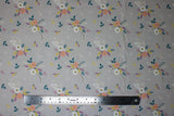 Flat swatch Pink & Purple fabric (grey fabric with loosely tossed floral clusters and leaves allover in green, white, pink, purple, turquoise)