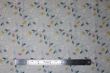 Flat swatch Green & Orange fabric (grey fabric with tossed leaves, sprigs and berry dots in orange, white, green, turquoise)