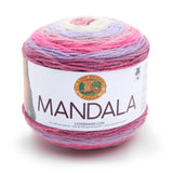 A cake of Lion Brand Mandala yarn in colourway wood nymph (baby pink, lavender, pink, hot pink, dusty rose)