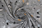 Swirled swatch Play Kitty fabric (grey fabric with doodle style cats allover in various colours all playing, tossed balls of yarn and small white cursive text "play" "kitty" etc.)