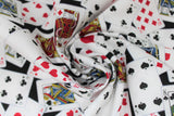 Swirled swatch man cave themed fabric in cards black (deck of cards face up tossed collage on black background)