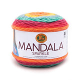 A cake of Lion Brand Mandala Sparkle yarn on white background in colourway hercules (orange, pink, aqua, yellow, orange yarn with metallic sparkles throughout)