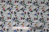 Flat swatch Bob Ross collection fabric in paint print (collage of white paint tubes with coloured tops and black/white Bob Ross heads)