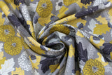 Swirled swatch Flint fabric (grey fabric with busy collaged greyscale and yellow toned leaves, tree sprigs, pinecones, acorns and floral heads)
