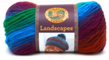 A ball of Lion Brand Landscapes yarn on white background in colourway apple orchard (bright green, bright blue, purple, dark red/orange)
