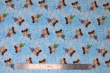 Flat swatch magical themed printed fabric in print fairies (light blue marbled fabric with tiny blue stars and cartoon brunette fairies with two side buns and gold star wands, pink/blue/green/purple dresses)