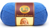 A ball of Lion Brand Pound of Love yarn on white background in shade denim (bright medium blue)