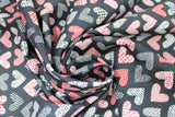Swirled swatch Black Patchwork Hearts fabric (black fabric with hearts allover in patchwork style in white, red and black colours)