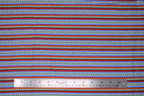 Flat swatch morning stripes fabric (red, green, blue striped pattern with yellow floral within blue stripes, decorative slashes in green/red stripes)
