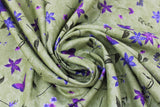 Swirled swatch Celery II fabric (medium green fabric with loosely tossed purple and green floral and greenery allover in various styles)