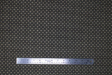 Flat swatch nightfall link fabric (dark grey/black fabric with beige tiled/linked look and beige squares tilted to look like diamonds on intersecting points)