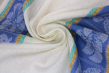 Swirled swatch Blue Butterflies t-toweling (white fabric with medium blue, teal and mustard top and bottom borders with floral and butterflies within)