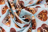 Swirled swatch Hearts fabric (pale blue fabric with paw prints in background and tossed heart badges allover with dog faces within)