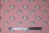 Flat swatch unicorns pink fabric (baby pink fabric with medium sized white unicorn heads with grey manes, pink purple and blue decorative floral with greenery)