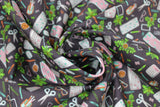 Swirled swatch desk flat lay fabric (black fabric with tossed desk item graphics in various colours: keyboard, calculator, scissors, plants, coffee mug, etc.)