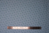 Flat swatch Paw Prints fabric (pale blue fabric with pale teal paw prints allover)