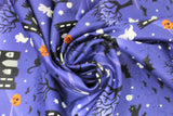 Swirled swatch Night Blue fabric (dark purply blue fabric with subtle hills look and black cartoon castles, tossed small halloween friends: white ghosts and skulls, black cats and bats, orange jack-o-lanterns)
