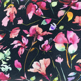 Square swatch knit material in botanical black (pink flowers with green and yellow leaves on black with a slight watercolour look)