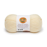 A ball of Lion Brand Touch of Alpaca yarn in cream shade on white background